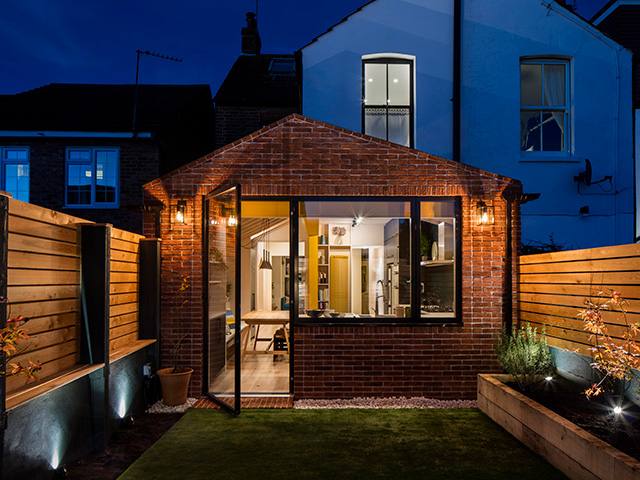 external shot of kitchen extension at nighttime - grand designs