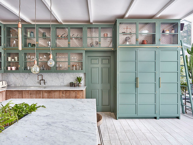 green kitchen with floor to ceiling storage- grand designs 