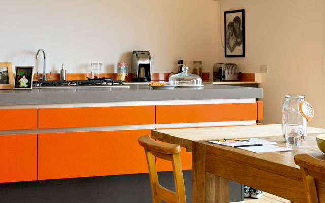 A bright orange kitchen in the Grand Designs Lake District house