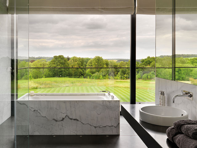 This new-build bathroom has a full-height, full-width bathroom window