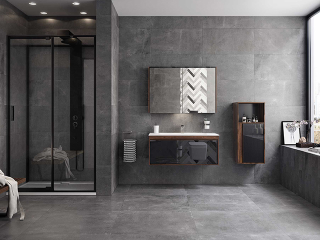 black framed shower enclosure in a large suite with grey tiles and floating furniture