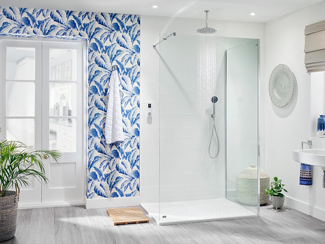 Blue bathroom wallpaper in a modern shower room with frameless shower screen 