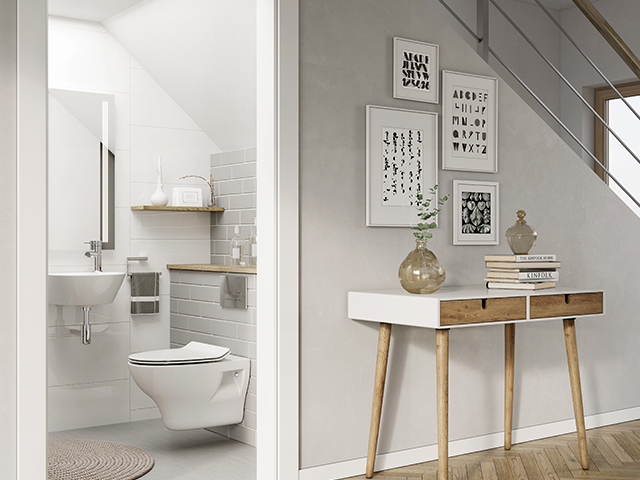 small downstairs bathroom under the stairs with grey and white tiles and white bathroom suite