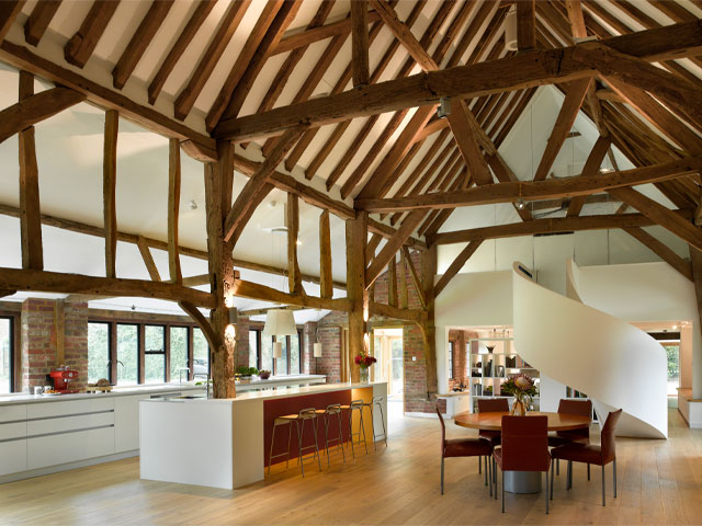 modern kitchen in a barn conversion with exposed timber beams