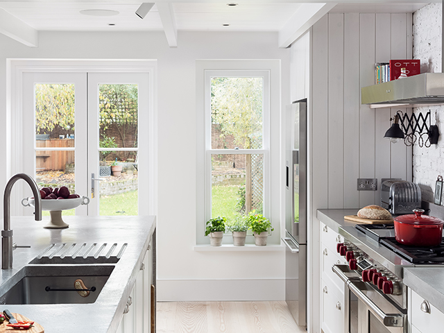 White paint and white wooden panels in a rear extension in the style of a New England beach house