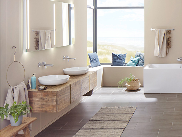 wooden floating double vanity with counter top basins in a natural decor scheme