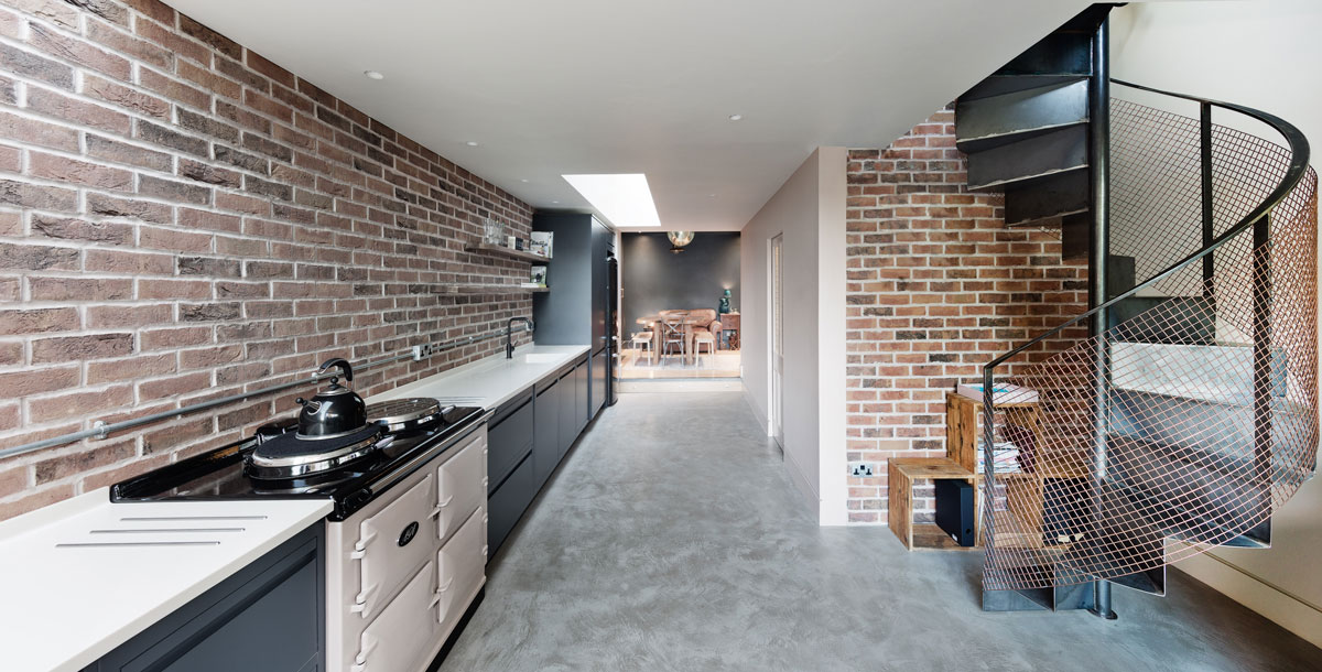 kitchen of corten steel extension with brick walls