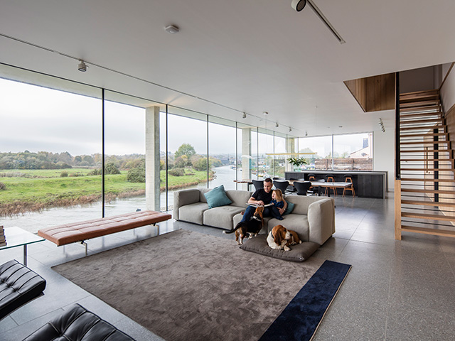 The self build house has triple-glazed frameless windows wrapping around an impressive open-plan living area with spectacular riverside views. Photo: Matt Chisnall