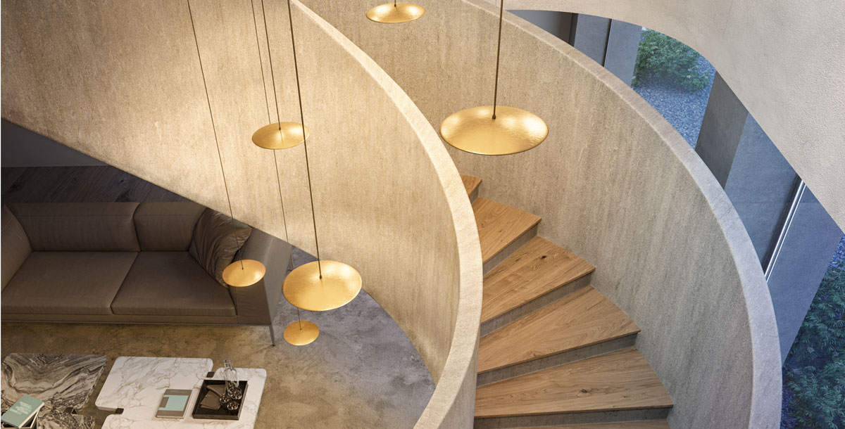 Cluster of golden pendant lights hanging above a staircase