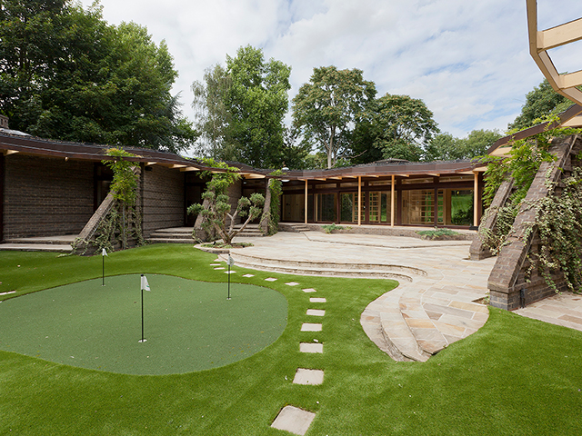 Outdoor putting green in garden of Grand Designs Hertfordshire Abbey house