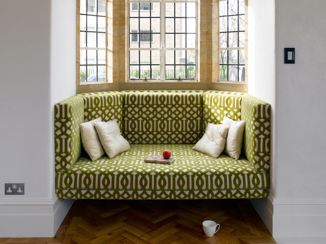 Grand Designs recording studio. Green graphic print sofa in bay window