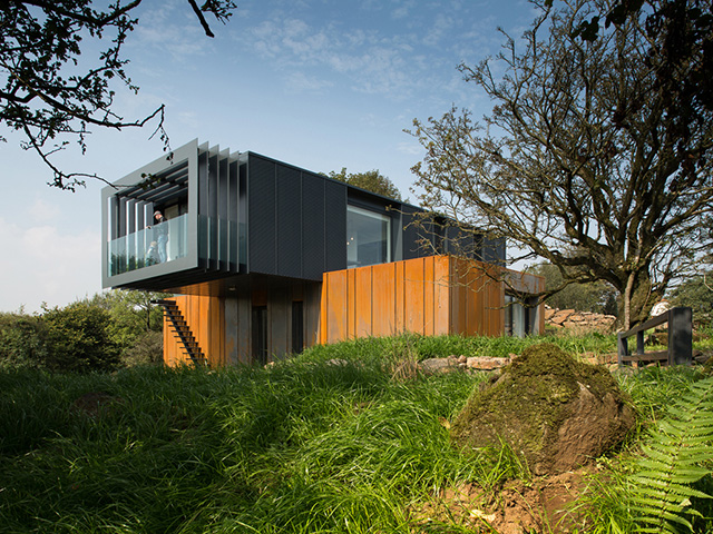 The exterior of a cantilever building created by placing one shipping container on top of the other.