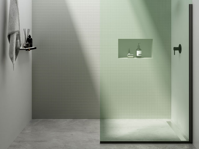 wet room with mosaic tiles and green tinted curved shower screen