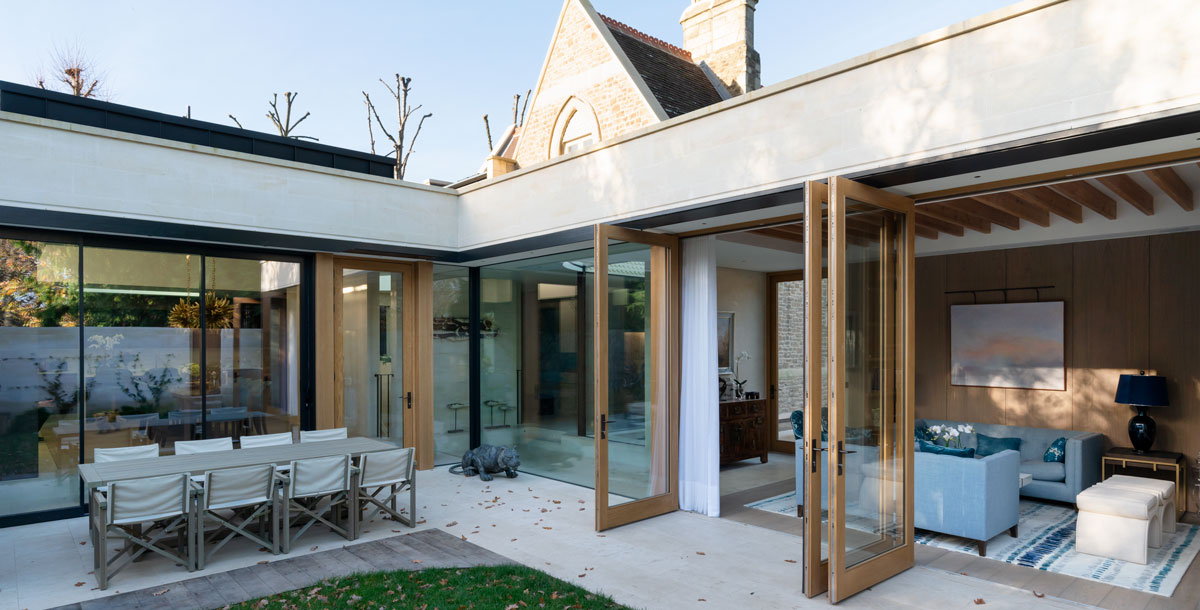 Rear view of the Grand Designs graveyard house with bi-folding doors to the modern extension open