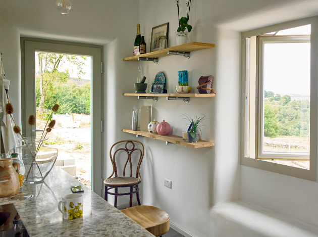 interior of kitchen with windows opening out onto view