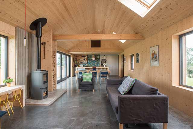 inside the timber-clad Grand Designs Ballygowan barn with log burner