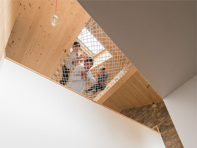 Ballygowan barn is a playful house with a cargo net suspended over the stairs for the kids to climb on