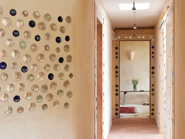 Glass bottles are set in the walls of Grand Designs earthship house. Photo: Chris Tubbs