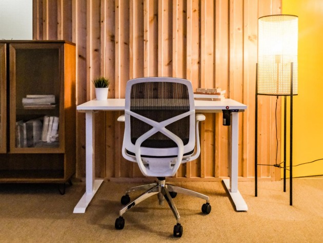 white home office desk with ergonomic chair and lamp