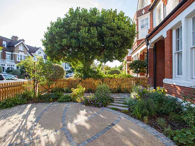 Urban front garden with planting around a circular drive.
