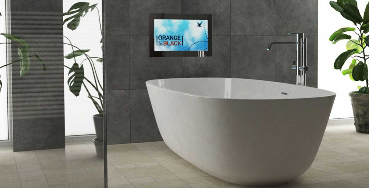 https://www.granddesignsmagazine.com/wp-content/uploads/2021/05/bathroom-with-waterproof-tv-installed-above-bath-tub.jpg