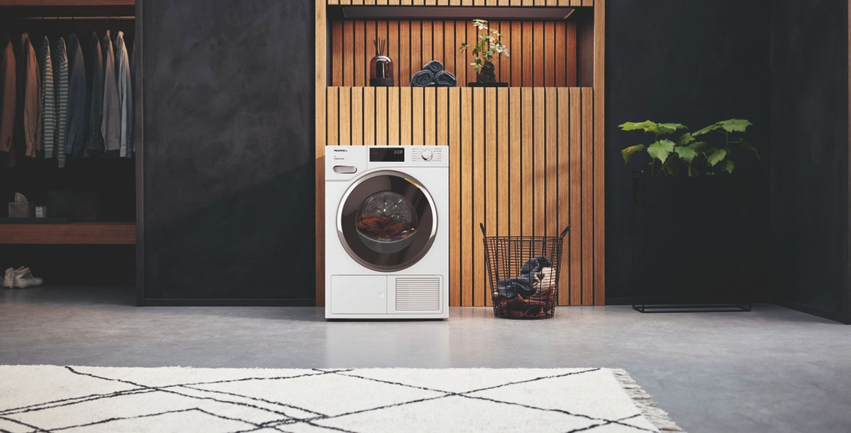 Quiet washing machine in an open-plan ktichen diner with wooden panelling