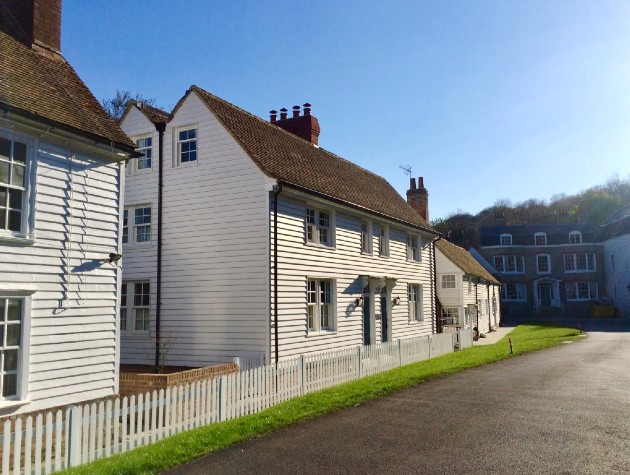 Exterior view of new homes with white weatherboarding by Waterhouse Architects