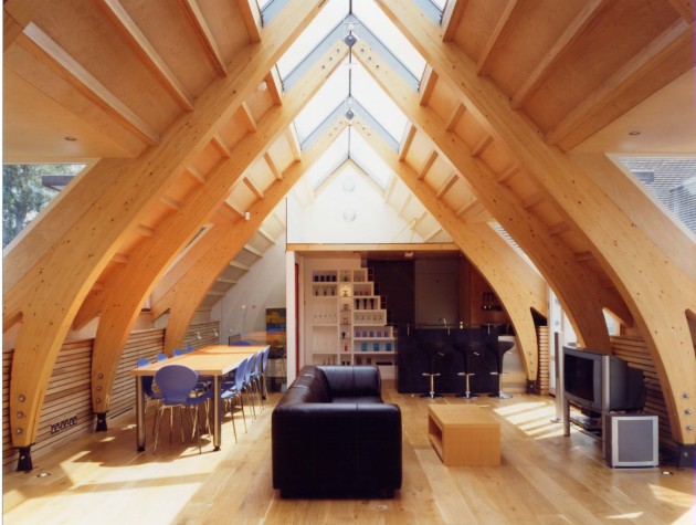 Interior of a timber and glass extension featuring curved beams by Waterhouse Architects