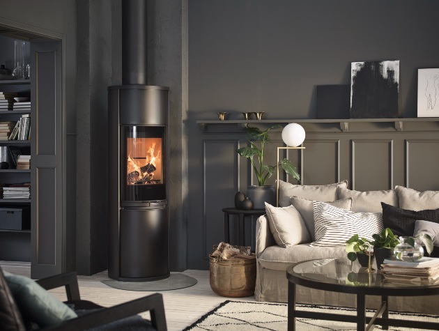 lounge in dark grey shades with sofa table and modern wood burning stove in corner