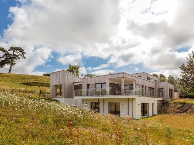 beautiful eco house in the country with wraparound balcony and views over wildflower fields