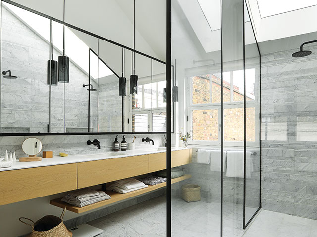 Main en suite bathroom with two basins and a ceiling skylight.