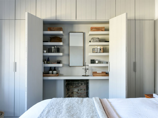 Built-in wardrobes are a great way to use the alcoves beside a bedroom chimney breast for maximum storage