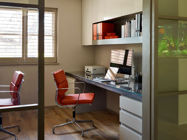 Devote a whole wall to shelving and go all the way up to the ceiling for more storage