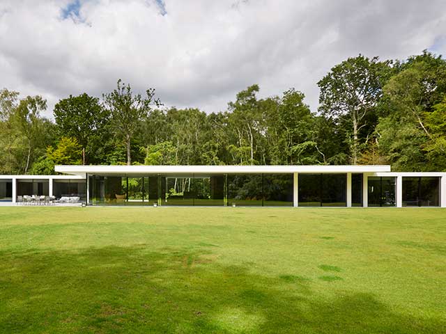 Grand Designs West Sussex bungalow exterior with green grass and trees surrounding