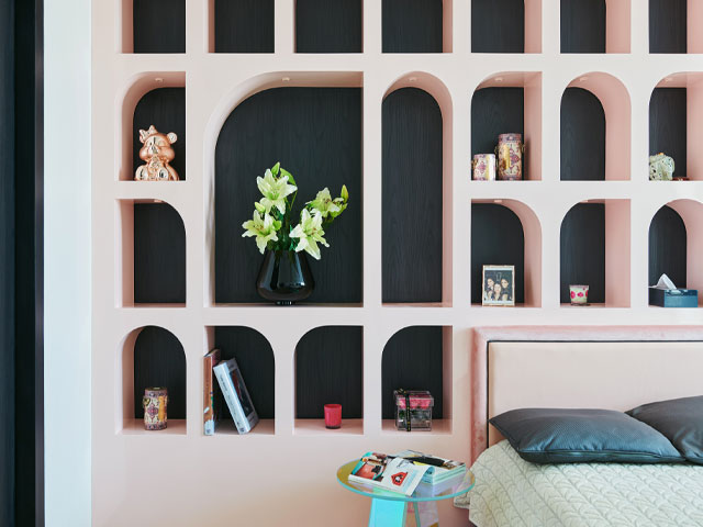 Furnitecture wall shelving unit in pink in a modern bedroom