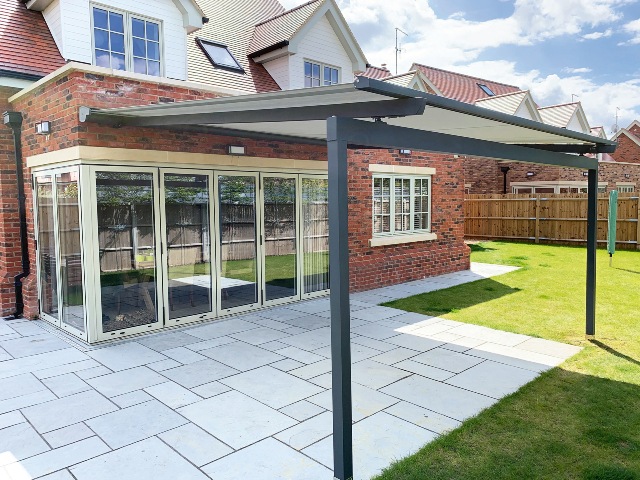 garden trends awnings over patio with bifold doors on redbrick house