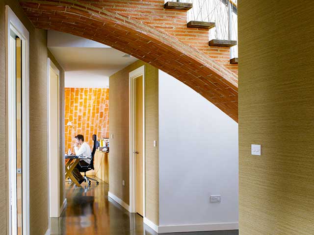 Brick stairs and below a hallway leading to the dining room