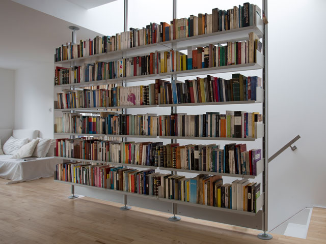 Modular shelving in a loft bedroom - modular shelving units offer multiple storage options