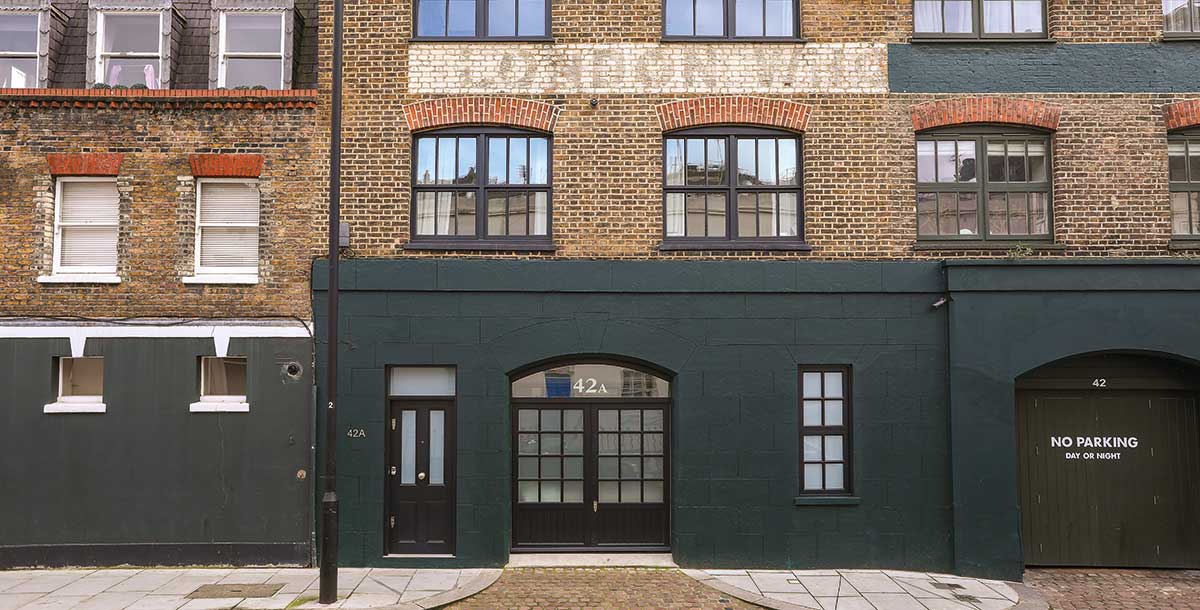 Victorian stable block renovation in Paddington with black-rendered brickwork