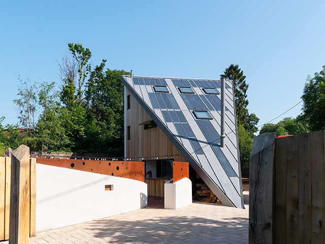 Sloping roof of Grand Designs triangle house with solar panels