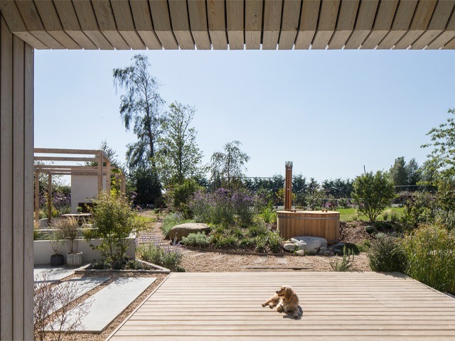 Grand Designs pond house in Chichester looking out over the decking to the swimming pond