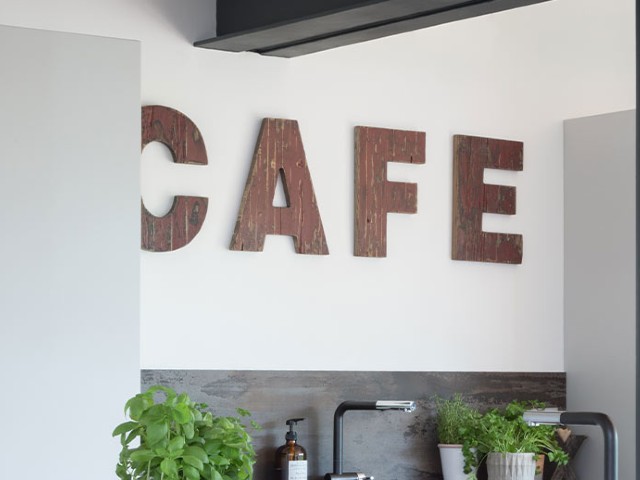 cafe sign in salvaged materials in an industrial-style kitchen