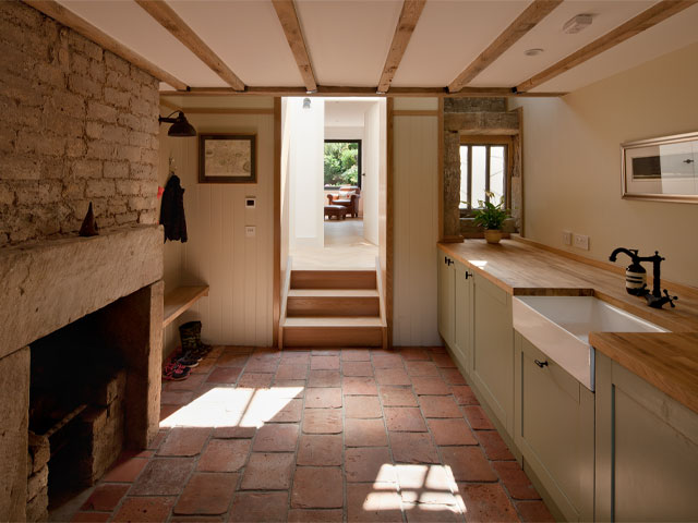 Inside the kitchen of the Grand Designs Scottish bothy with a view out to the formal garden