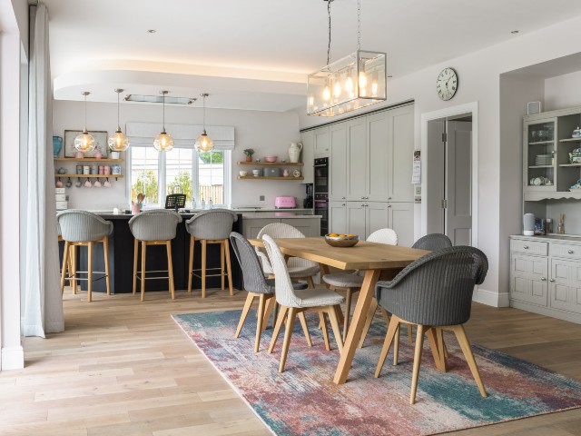 contemporary kitchen diner professionally decorated in neutrals with large pastel rug