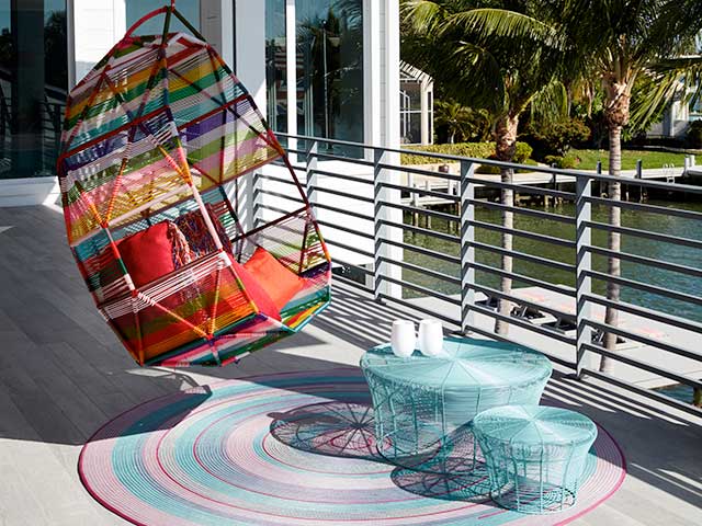 Multicoloured swinging chair on balcony of Florida villa