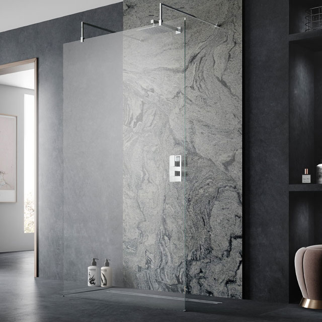 walk-through shower with frameless screen and dark marble bathroom tiles