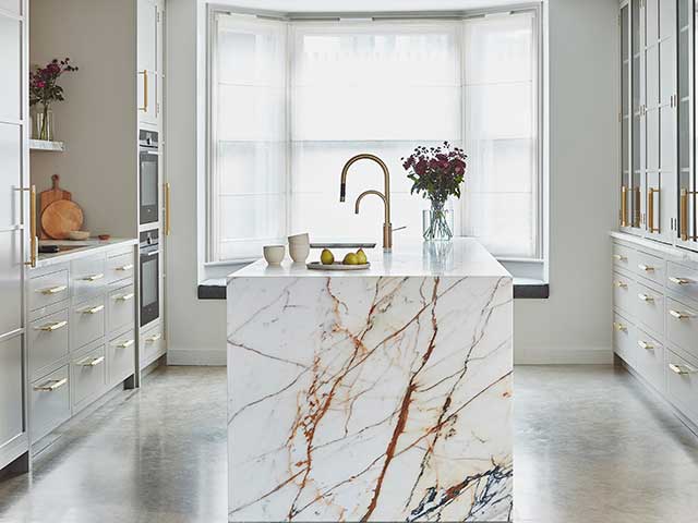 white and gold marble kitchen island in period home with modern white kitchen