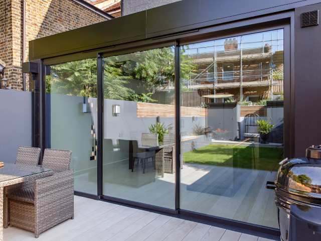 Sliding glass doors overlooking courtyard and rattan chairs