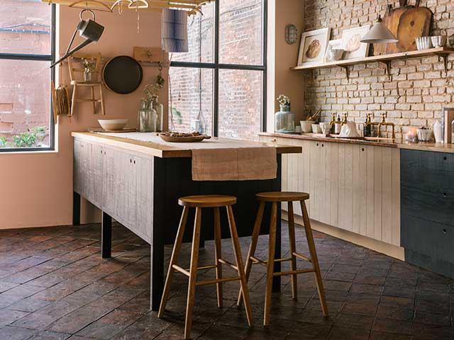 freestanding kitchen island painted dark in a country-style kitchen