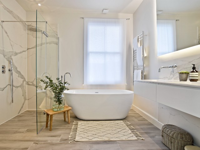 Freestanding bath in contemporary design-led bathroom with walk-in shower